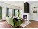 Bright living room with hardwood floors, fireplace, and large windows with green curtains at 2098 N Clarkson St, Denver, CO 80205