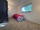 Bedroom with a window overlooking green trees, carpet and a bed at 3902 S Uravan St, Aurora, CO 80013