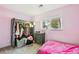 Bedroom with pink walls, carpeted floors, and a closet, creating a cozy and stylish space at 3902 S Uravan St, Aurora, CO 80013