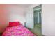 Bedroom with pink walls and carpeted floors featuring a walk in closet and lots of room at 3902 S Uravan St, Aurora, CO 80013
