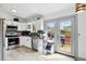 Modern kitchen with stainless steel appliances and ample natural light from the door to the deck at 3902 S Uravan St, Aurora, CO 80013