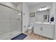 Clean bathroom with glass-enclosed shower, white vanity, and contemporary fixtures at 1086 Highlands Dr, Erie, CO 80516