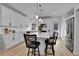 Bright kitchen featuring white cabinets, stainless steel appliances, and a center island with bar stool seating at 1086 Highlands Dr, Erie, CO 80516