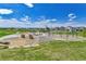 A neighborhood playground with climbing structures, swings, and a grassy field for activities at 1086 Highlands Dr, Erie, CO 80516