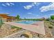 Outdoor pool and clubhouse with a slide on a sunny day with blue skies at 1086 Highlands Dr, Erie, CO 80516