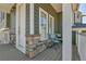Covered porch with chairs and stone accents at 1086 Highlands Dr, Erie, CO 80516