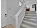 Interior view of a carpeted staircase with white walls and wood floors at 1086 Highlands Dr, Erie, CO 80516