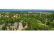 An aerial shot captures the homes nestled within a leafy neighborhood with distant mountain views at 7308 S Steele Cir, Centennial, CO 80122