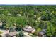 An aerial view showcases the property's lush green surroundings and the distant city skyline at 7308 S Steele Cir, Centennial, CO 80122
