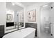 Soaking tub featuring a modern design, tile accent wall, and a picture window at 7308 S Steele Cir, Centennial, CO 80122