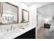 Bright bathroom featuring dual sinks, quartz countertops, and modern fixtures at 7308 S Steele Cir, Centennial, CO 80122