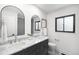 Bathroom with dual sinks, marble counters, and decorative mirrors at 7308 S Steele Cir, Centennial, CO 80122