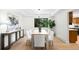 Bright dining room with modern lighting, neutral decor, and large windows overlooking greenery at 7308 S Steele Cir, Centennial, CO 80122