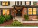 Attractive home entryway featuring a brick facade, well-maintained landscaping, and a welcoming front door with glass detailing at 7308 S Steele Cir, Centennial, CO 80122