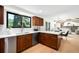 Kitchen features stainless steel appliances, wood cabinetry, and an eat-in breakfast bar at 7308 S Steele Cir, Centennial, CO 80122