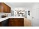 Open floor plan, kitchen with stainless steel appliances and natural wood cabinets at 7308 S Steele Cir, Centennial, CO 80122