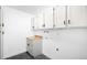 Bright laundry room features white cabinets and a butcher block countertop for folding and cleaning at 7308 S Steele Cir, Centennial, CO 80122