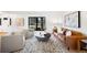 Inviting living room with hardwood floors, stylish furniture, a large window, and modern artwork at 7308 S Steele Cir, Centennial, CO 80122