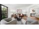 Bright living room featuring neutral decor, hardwood floors, large windows, and comfortable seating arrangements at 7308 S Steele Cir, Centennial, CO 80122