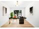 Home office featuring a modern desk, comfortable chair, and ample natural light from the large window at 7308 S Steele Cir, Centennial, CO 80122