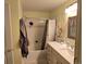 Well-lit bathroom with a vanity, mirror, tub, shower with a modern shower curtain and neutral walls at 7440 S Blackhawk St # 2-106, Englewood, CO 80112