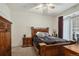 Cozy bedroom featuring wooden furniture including a bed, bedside tables, and a dresser at 7440 S Blackhawk St # 2-106, Englewood, CO 80112