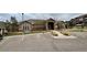 Exterior of community clubhouse, featuring stone accents, large windows, and well-maintained landscaping at 7440 S Blackhawk St # 2-106, Englewood, CO 80112