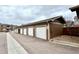 Row of private garages with clearly marked unit numbers, offering convenient parking for residents at 7440 S Blackhawk St # 2-106, Englewood, CO 80112
