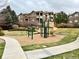 Community playground with slides and climbing structures, set amongst mature trees and green space at 7440 S Blackhawk St # 2-106, Englewood, CO 80112