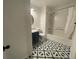 Updated bathroom with black and white patterned floor at 269 Ponderosa Pl, Fort Lupton, CO 80621