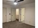 Bedroom with ceiling fan, carpet, and multiple doors at 269 Ponderosa Pl, Fort Lupton, CO 80621