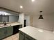 Modern kitchen with island, stainless steel appliances, and green cabinets at 269 Ponderosa Pl, Fort Lupton, CO 80621