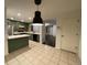Eat-in kitchen with island, stainless steel appliances, and green cabinets at 269 Ponderosa Pl, Fort Lupton, CO 80621