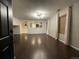 Spacious living room featuring dark hardwood floors and a view into the kitchen at 269 Ponderosa Pl, Fort Lupton, CO 80621