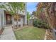 A modern townhome showcasing a backyard with manicured artificial turf and mature trees for added privacy at 1655 N Williams St, Denver, CO 80218