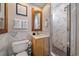 Well-appointed bathroom with marbled walls, framed mirror, and a glass-enclosed shower at 1655 N Williams St, Denver, CO 80218