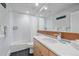 Clean bathroom featuring a bathtub, shower, and a well-lit vanity with a large mirror at 1655 N Williams St, Denver, CO 80218