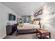 Cozy bedroom with warm lighting, stylish artwork, and a view of the lush outdoor scenery at 1655 N Williams St, Denver, CO 80218