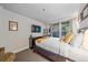 Relaxing bedroom features a mounted TV and bright light shining in from the outside at 1655 N Williams St, Denver, CO 80218