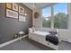 Bright bedroom featuring a large window, gray accent wall, and a comfy bed with built-in storage at 1655 N Williams St, Denver, CO 80218