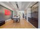 Bright dining room featuring hardwood floors, modern light fixture, and a view of the staircase at 1655 N Williams St, Denver, CO 80218
