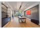 Dining room with hardwood floors, modern light fixture, integrated cabinets, and access to living spaces at 1655 N Williams St, Denver, CO 80218