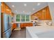 Bright kitchen features light wood cabinetry, stainless steel appliances, and a large window over the sink at 1655 N Williams St, Denver, CO 80218