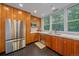 Contemporary kitchen boasting wood cabinets, stainless steel appliances, and a bright window overlooking trees at 1655 N Williams St, Denver, CO 80218
