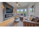 Modern living room boasts a sleek fireplace, large windows, and comfortable seating at 1655 N Williams St, Denver, CO 80218