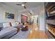 Open-concept living room with hardwood floors, fireplace, and seamless flow to the dining area at 1655 N Williams St, Denver, CO 80218