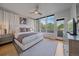 Spacious bedroom with hardwood floors, lots of natural light, and a door leading to a balcony at 1655 N Williams St, Denver, CO 80218