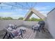 Cozy rooftop deck with string lights, a seating area, and a grill for outdoor entertaining at 1655 N Williams St, Denver, CO 80218
