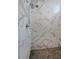 Elegant shower with rainfall head and marble-patterned tile walls, and a stylish hexagon tile floor at 1655 N Williams St, Denver, CO 80218