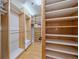 Spacious walk-in closet with custom shelving, hardwood floors, and ample storage solutions at 1655 N Williams St, Denver, CO 80218
